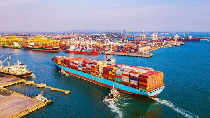 Illustrative cargo vessels and containers at a port